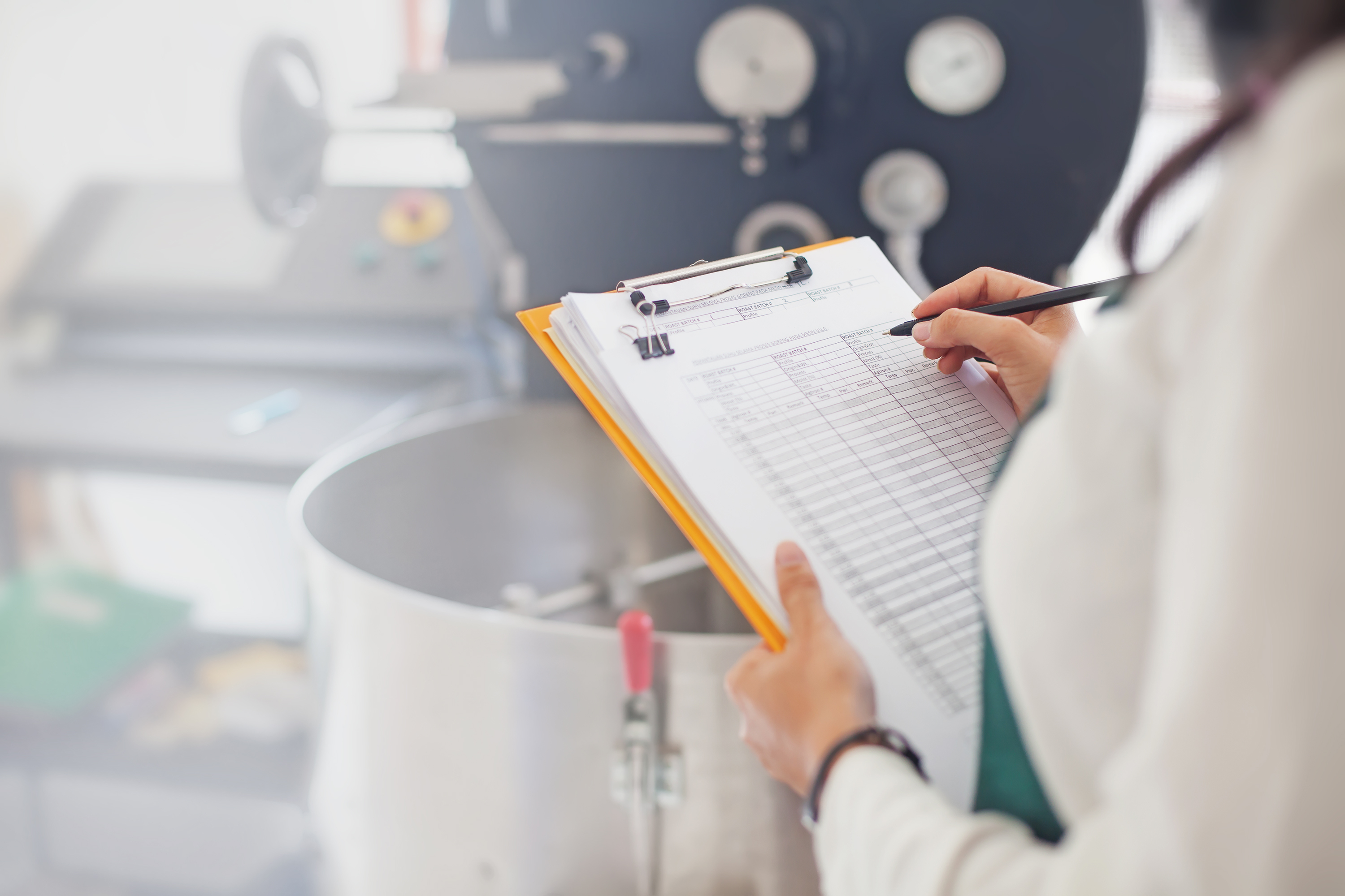 Woman Holding a Clipboard With A Kosher Checklist Next to Equipment